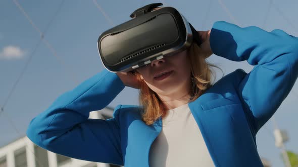 Woman Wearing Virtual Reality Headset and Start to Use Virtual Interface alt