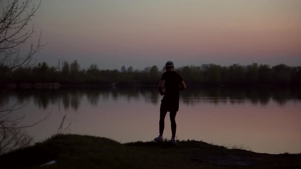 Triathlete Sport Recreation Run Workout On Sunset. Runner Silhouette Jogging At Dusk On Trail. alt