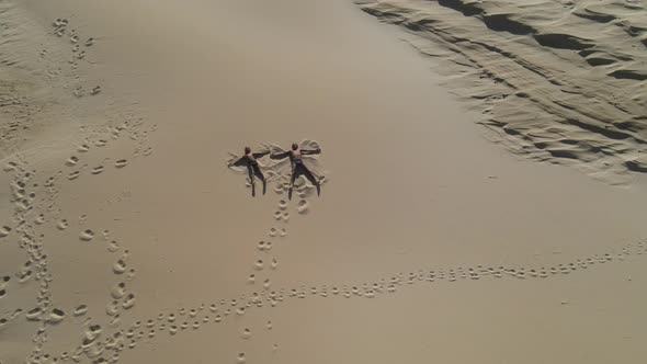 Drone View of Kids Seen Laying and Playing on Sand Dune
