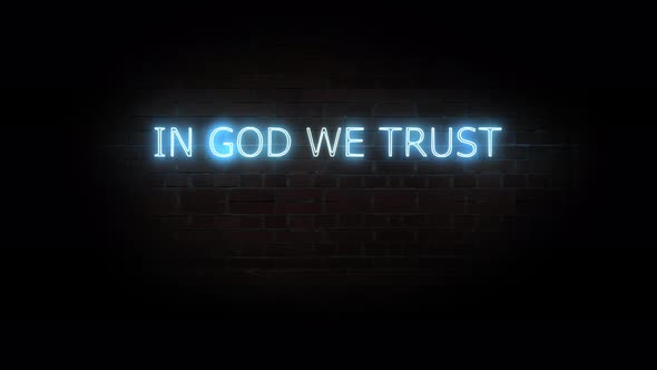 In god we trust.Text neon light on brick wall background.