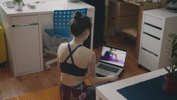 Healthy Lifestyle in Pandemic Time. Young Fit Sporty Brunette Girl Pumping Muscles with Dumbbells alt