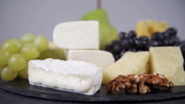A Cheese Plate with Various Fruits Rotates on Its Axis