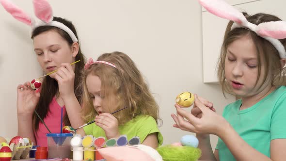 Girls Prepare for the Easter Holiday and Paint Chicken Eggs