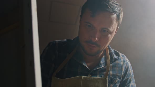 Caucasian Man Draws Pictures with Oil on the Grass alt