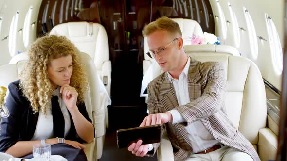 Business people discussing over digital tablet 4k alt