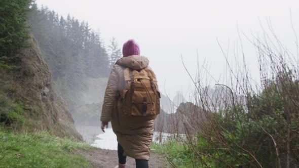 Slow Motion Woman Enjoying Breathtaking View on Rainy Day Staying at Sea Rock alt