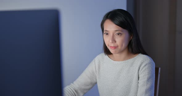 Woman work on computer at home in the evening alt