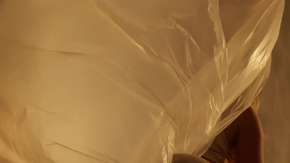 Closeup of a Professional Dancer Performing in Studio in Soft Warm Lighting alt