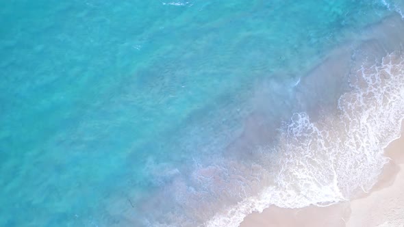 Beautiful colorful sea waves crashing on sandy shore.White sand and amazing sea background. Summer alt