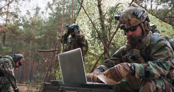 A Bearded Brigade Commander in a Military Uniform with a Helmet on His Head Checks the Coordinates alt
