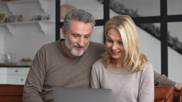 Cheerful Middleaged Spouses Raising Hands Up in Victory Gesture Triumph alt