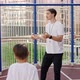 School Coach Mentoring Kids How to Catch and Throw the Ball on Basketball Court Outdoor - VideoHive Item for Sale
