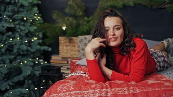 Beautiful Woman Fashion Model. Fashion interior view of beautiful sensual woman lying on bed alt