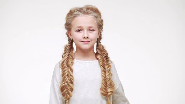 Young Beautiful Caucasian Girl with Long Luxurious Blonde Hair Standing on White Background and alt