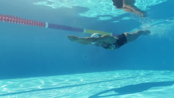 Woman Is Swimming Underwater in Pool During Triathlon Training