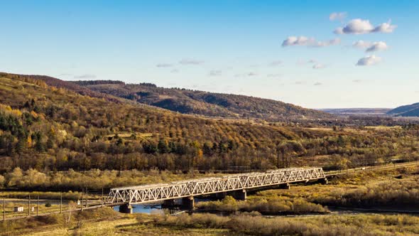 Railroad Bridge Over River in Highland with Colorful Trees