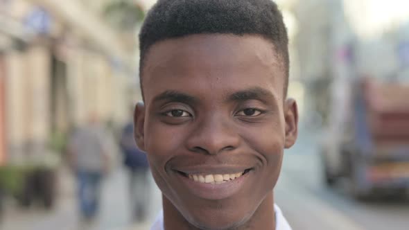 Face Close Up of African Man Smiling at Camera alt