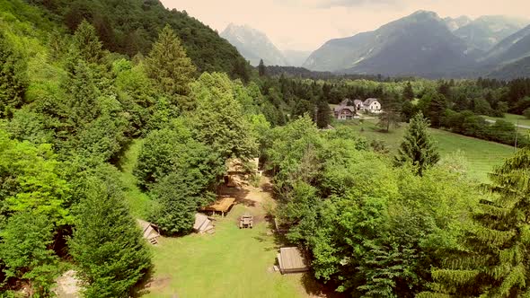 Aerial view of summer camp with small camping cabins and recreational area. alt