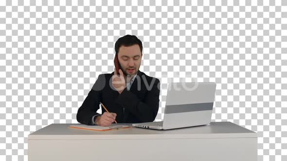 Young business man speaking on the phone in office., Alpha Channel