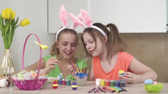 Girls Decorate Easter Eggs and Help Each Other Talk and Laugh