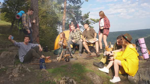 Young People Having a Rest Outdoors, Planning Their Travel. alt
