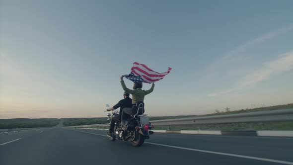 Woman and Man are Riding Motorcycle on Highway Sunset alt