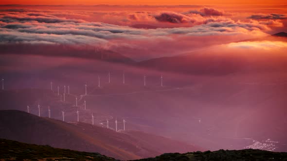 Wind Turbines At Sunset Above Clouds, Portugal.