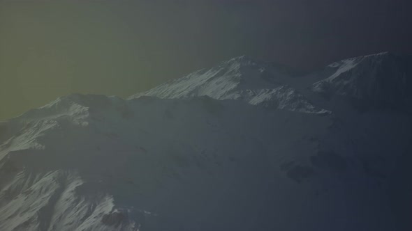 Dramatic Dark Rocky Mountain with Patches of Snow in Storm alt