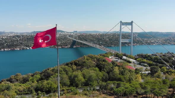 Aerial view of Fatih Sultan Mehmet Bridge and Turkish Flag alt