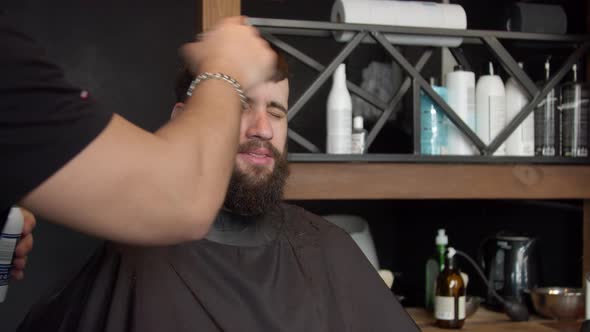 Barber Cleaning Face of Client with Neck Duster