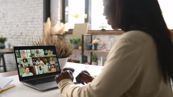 Young AfricanAmerican Woman Using Laptop for Virtual Meeting with Colleagues