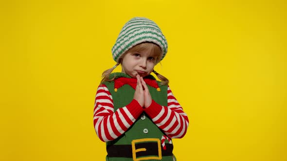 Kid in Christmas Elf Santa Helper Costume Begs Prays About Gifts on New Year alt