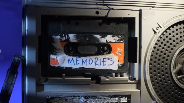 Close Up Footage Dolly of Old Audio Cassette with Inscription MEMORIES alt