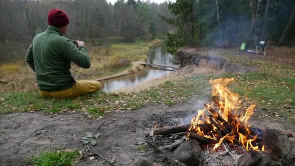 Traveler Man Stands in Picturesque Place of Wildlife and Looks at Beautiful Autumn Forest