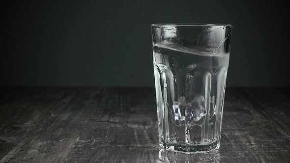 Two Ice Cubes Fall Into a Glass of Water