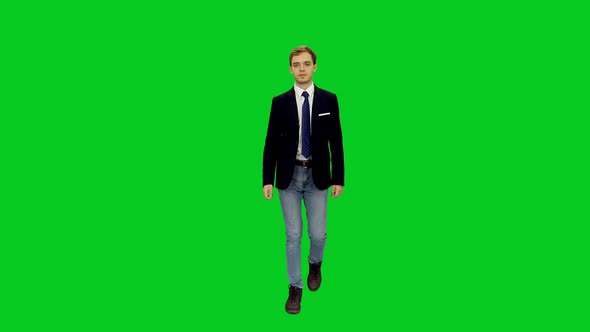Good Looking Young Business Man In Suit Jacket And Jeans Walking on Green Screen
