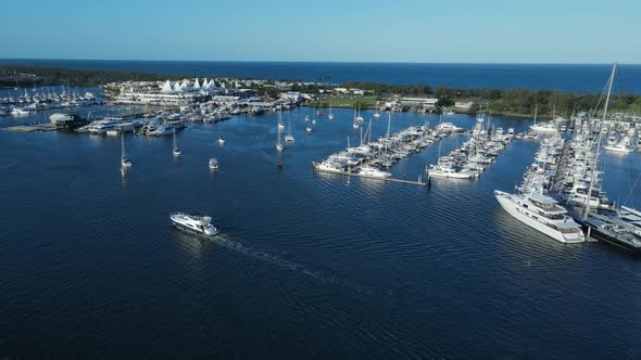 A high panning view of a city marina located inside a protected urban boat harbor on the Gold Coast alt