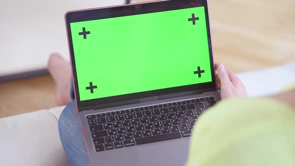 Closeup of Chromakey Green Screen Laptop with Female Caucasian Hand Pressing Keyboard alt
