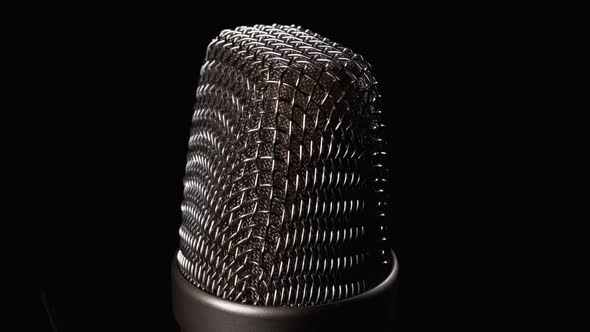 Studio Condenser Microphone Rotates on Black Background alt