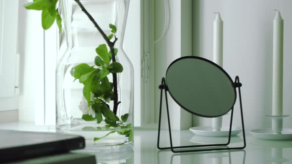 Mirror, Book Interior Details on Windowsill Spbd Flowers in Vase in Daylight. Comfortable Cozy Space