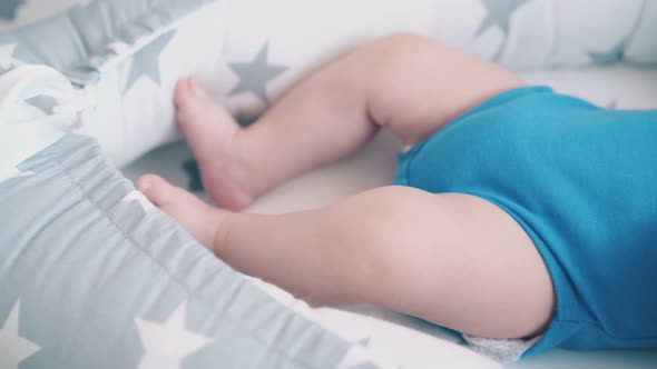 Motion Above Funny Boy Kicking Legs in Grey and White Cocoon alt