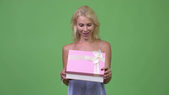 Young Happy Beautiful Businesswoman Opening Gift Box