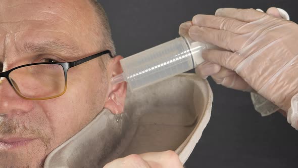 The Look of the Man While on an Ear Rinsing Procedure alt