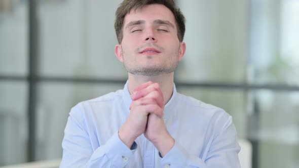 Young Man Praying with Eyes Closed alt