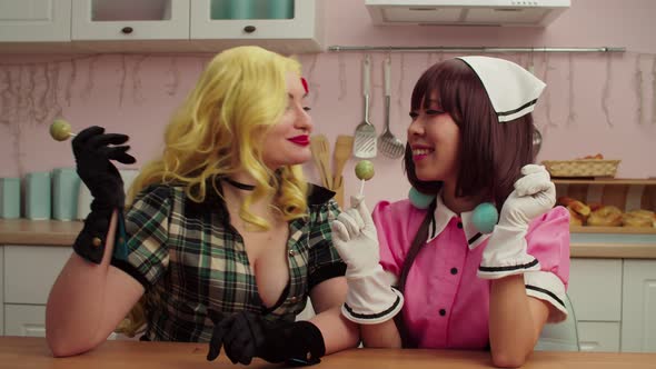 Playful Charming Multiethnic Females in Cosplay Costumes Licking Lollipops alt