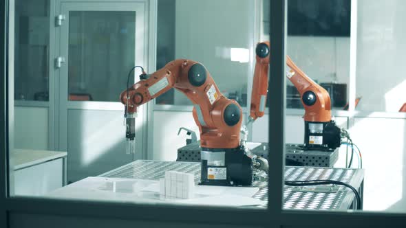 Modern Robotic Arms Work in Facility. alt