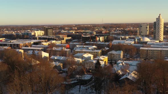 Drone shot over snowy roof tops of Karlova district towards to Snail tower Tigu torn alt