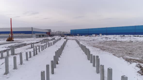 Aerial drone view of many reinforced concrete piles driven into the ground 11 alt