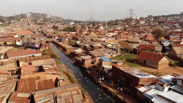 Drone Shot Over the Slums of Uganda Moving Along a River Poverty and Rubbish