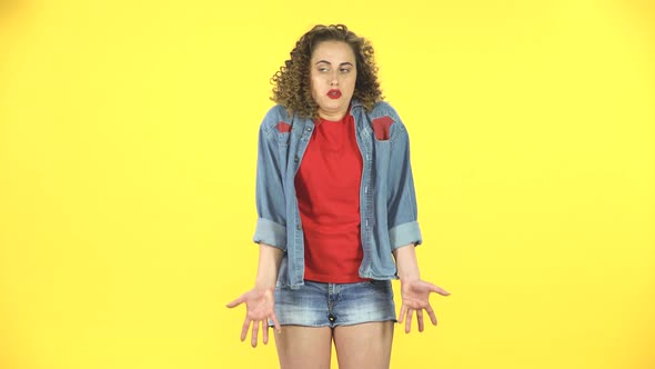 Woman Throwing Up Hands Expressing She Is Innocent, Saying Oops She Doesn't Know What's Going alt